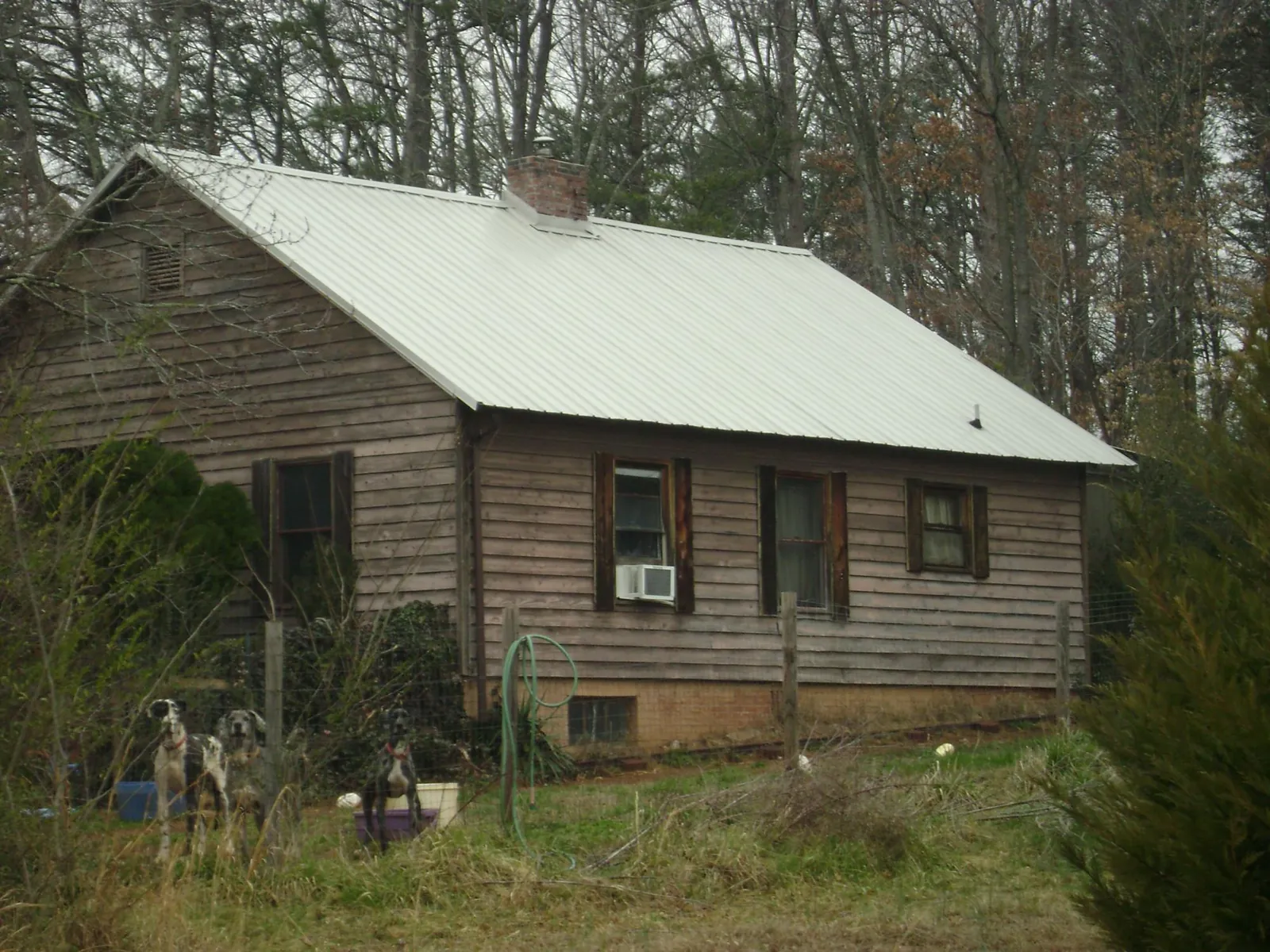 White metal roof on an old wood sided farmhouse, from a Metal Roof Installation job in North Bridgton